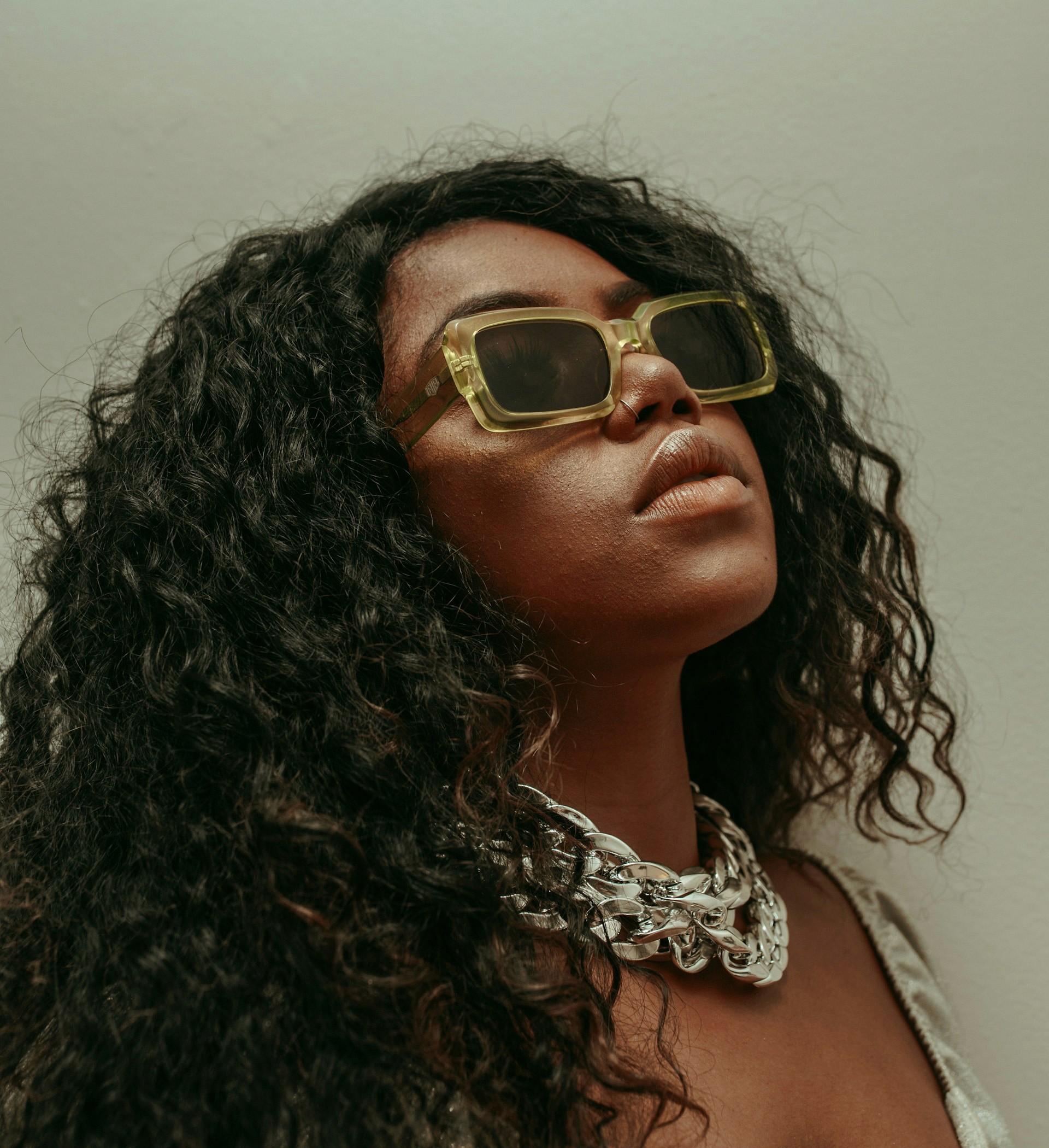 A young African woman wearing yellow sunglasses